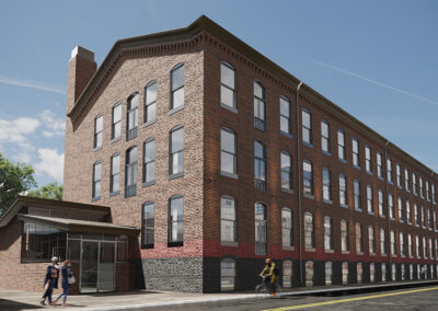 Exterior view of Westmoreland Lofts with people walking and riding bikes.